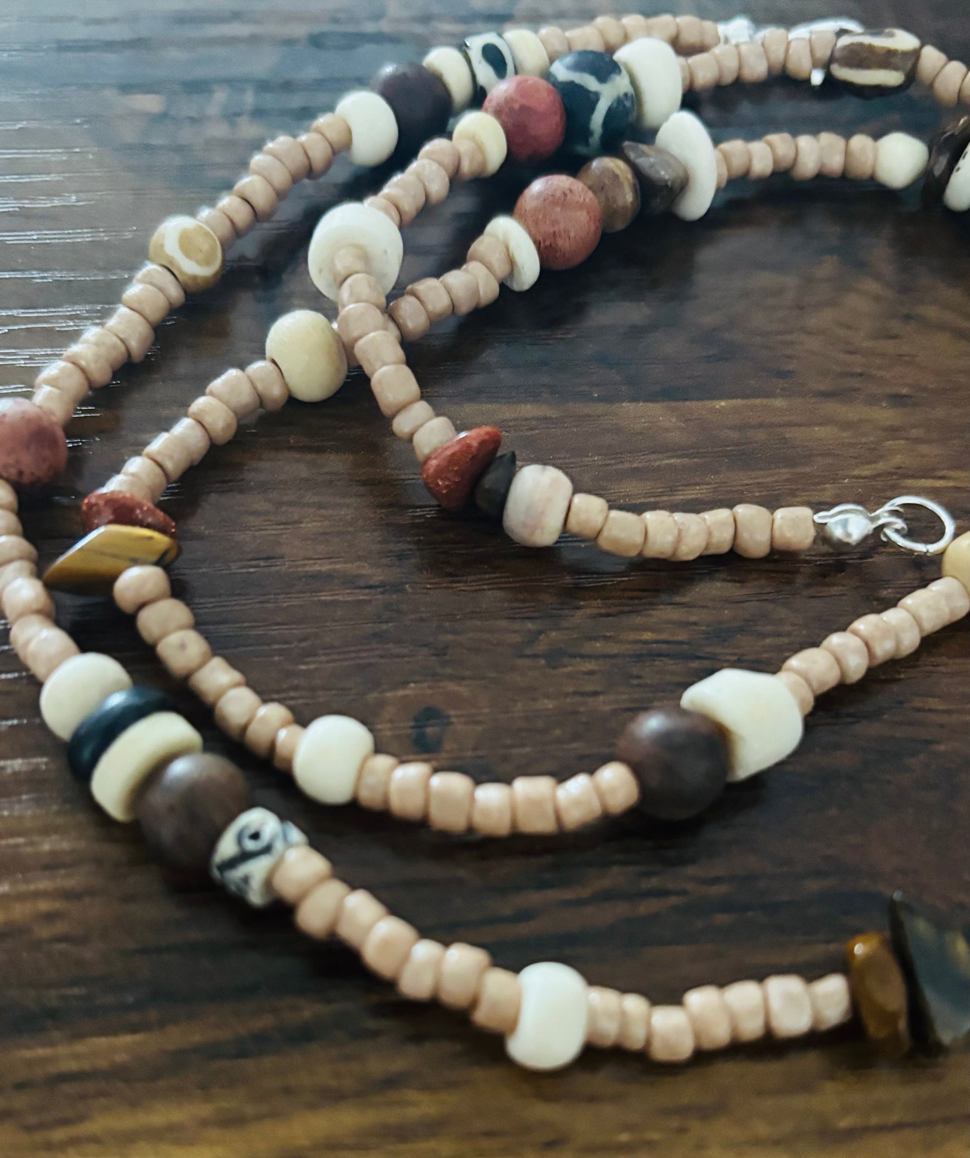 Waist Adornment with assorted beads on a wooden surface