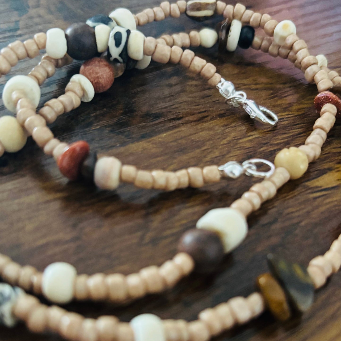 Waist Adornment with assorted beads on a wooden surface